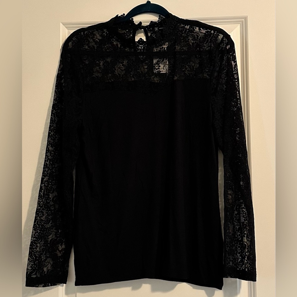 Black shirt with lace at the neckline and sleeves